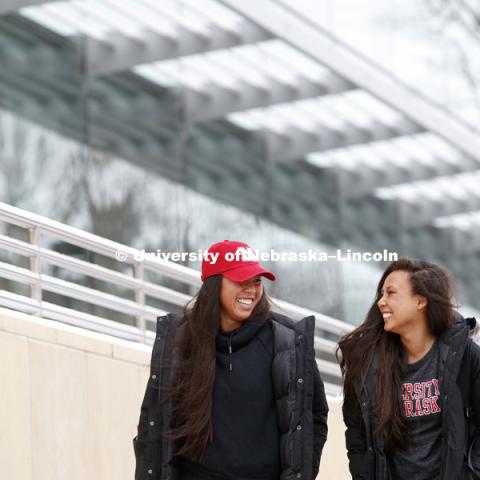 Lily Nguyen, senior in management, left, and Tammy Nguyen, junior in management, walk out of the College of Business building after classes Tuesday. Snowy day. January 23, 2018. Photo by Craig Chandler / University Communication.