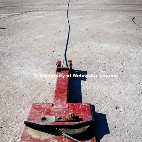 The test truck is pulled by cable down the tarmac and into the barrier being tested. Test of bull-nose barrier for use in medians to protect cars from overpass columns. Test was at university's Midwest Roadside Safety Facility at the Lincoln airport. June 5, 2018. Photo by Craig Chandler / University Communication.