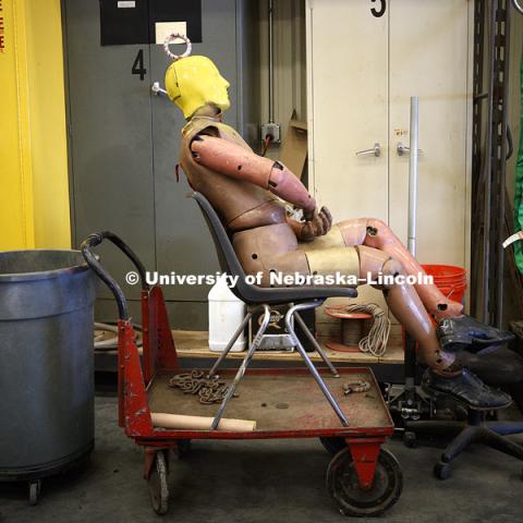 A crash test dummy awaits its turn in the facility garage. Test of bull-nose barrier for use in medians to protect cars from overpass columns. Test was at university's Midwest Roadside Safety Facility at the Lincoln airport. June 5, 2018. Photo by Craig Chandler / University Communication.