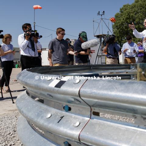 Bob Bielenberg, right, explains the new highway barrier being tested to the media and the NASCAR tour group. Test of bull-nose barrier for use in medians to protect cars from overpass columns. Test was at university's Midwest Roadside Safety Facility at the Lincoln airport. June 5, 2018. Photo by Craig Chandler / University Communication.