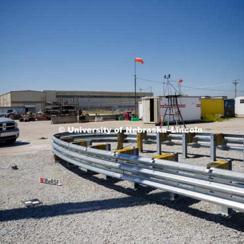 A truck is crashed in to a bull-nose barrier for use in medians to protect cars from overpass columns. The front wood pylons are designed to shear off easily along with several metal ones. The shearing allows the energy of the crash to be transferred into the ground. Cables in the guardrails are designed to keep the car or truck captive and not let it deflect back into traffic. Test was at university's Midwest Roadside Safety Facility at the Lincoln airport. June 5, 2018. Photo by Craig Chandler / University Communication.