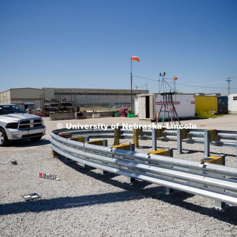 A truck is crashed in to a bull-nose barrier for use in medians to protect cars from overpass columns. The front wood pylons are designed to shear off easily along with several metal ones. The shearing allows the energy of the crash to be transferred into the ground. Cables in the guardrails are designed to keep the car or truck captive and not let it deflect back into traffic. Test was at university's Midwest Roadside Safety Facility at the Lincoln airport. June 5, 2018. Photo by Craig Chandler / University Communication.