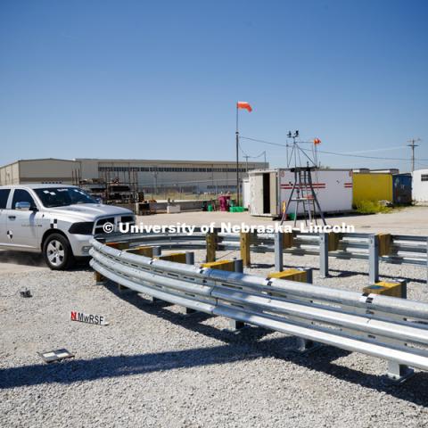 A truck is crashed in to a bull-nose barrier for use in medians to protect cars from overpass columns. The front wood pylons are designed to shear off easily along with several metal ones. The shearing allows the energy of the crash to be transferred into the ground. Cables in the guardrails are designed to keep the car or truck captive and not let it deflect back into traffic. Test was at university's Midwest Roadside Safety Facility at the Lincoln airport. June 5, 2018. Photo by Craig Chandler / University Communication.