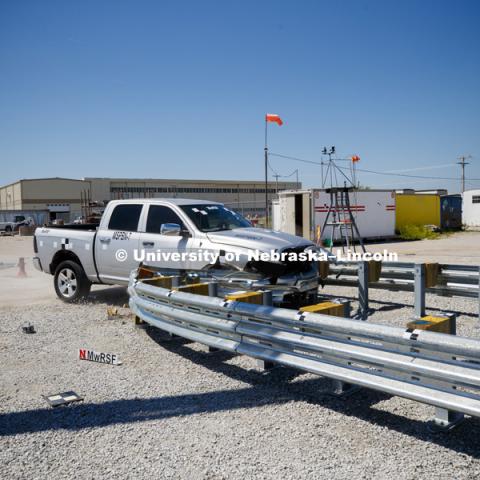 A truck is crashed in to a bull-nose barrier for use in medians to protect cars from overpass columns. The front wood pylons are designed to shear off easily along with several metal ones. The shearing allows the energy of the crash to be transferred into the ground. Cables in the guardrails are designed to keep the car or truck captive and not let it deflect back into traffic. Test was at university's Midwest Roadside Safety Facility at the Lincoln airport. June 5, 2018. Photo by Craig Chandler / University Communication.