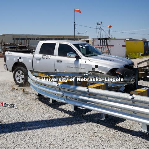 A truck is crashed in to a bull-nose barrier for use in medians to protect cars from overpass columns. The front wood pylons are designed to shear off easily along with several metal ones. The shearing allows the energy of the crash to be transferred into the ground. Cables in the guardrails are designed to keep the car or truck captive and not let it deflect back into traffic. Test was at university's Midwest Roadside Safety Facility at the Lincoln airport. June 5, 2018. Photo by Craig Chandler / University Communication.