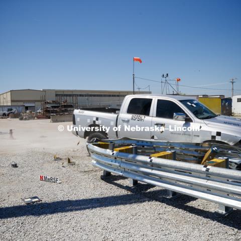 A truck is crashed in to a bull-nose barrier for use in medians to protect cars from overpass columns. The front wood pylons are designed to shear off easily along with several metal ones. The shearing allows the energy of the crash to be transferred into the ground. Cables in the guardrails are designed to keep the car or truck captive and not let it deflect back into traffic. Test was at university's Midwest Roadside Safety Facility at the Lincoln airport. June 5, 2018. Photo by Craig Chandler / University Communication.