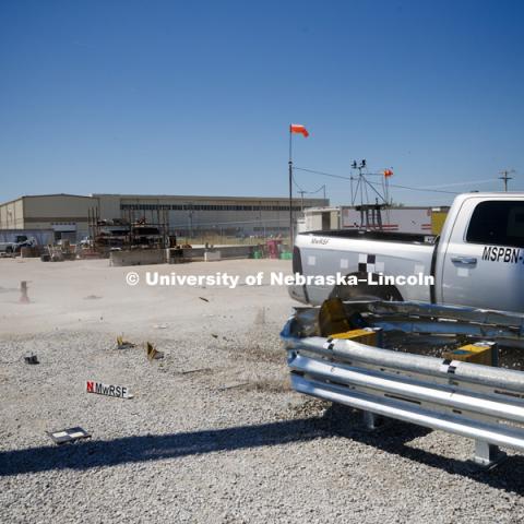 A truck is crashed in to a bull-nose barrier for use in medians to protect cars from overpass columns. The front wood pylons are designed to shear off easily along with several metal ones. The shearing allows the energy of the crash to be transferred into the ground. Cables in the guardrails are designed to keep the car or truck captive and not let it deflect back into traffic. Test was at university's Midwest Roadside Safety Facility at the Lincoln airport. June 5, 2018. Photo by Craig Chandler / University Communication.