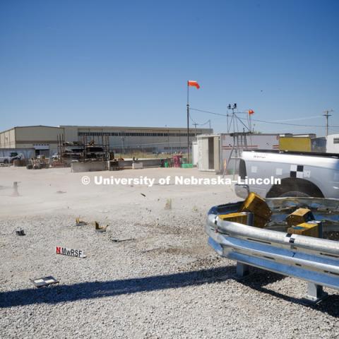 A truck is crashed in to a bull-nose barrier for use in medians to protect cars from overpass columns. The front wood pylons are designed to shear off easily along with several metal ones. The shearing allows the energy of the crash to be transferred into the ground. Cables in the guardrails are designed to keep the car or truck captive and not let it deflect back into traffic. Test was at university's Midwest Roadside Safety Facility at the Lincoln airport. June 5, 2018. Photo by Craig Chandler / University Communication.