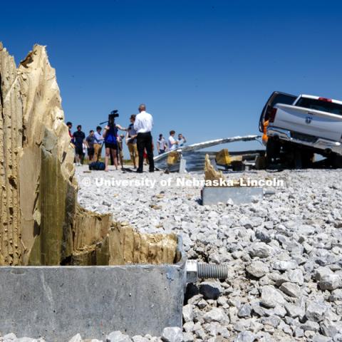 The remnants of the wood pylons on the barrier which are designed to snap off while absorbing the energy of the crash to help slowly stop the car. Test of bull-nose barrier for use in medians to protect cars from overpass columns. Test was at university's Midwest Roadside Safety Facility at the Lincoln airport. June 5, 2018. Photo by Craig Chandler / University Communication.