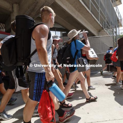 Band members head back to the Westbrook Music Building at the end of a couple hours on the Memorial Stadium turf. The day will continue with sectionals practice, dinner and a second practice session on the stadium field. Cornhusker Marching Band practice.