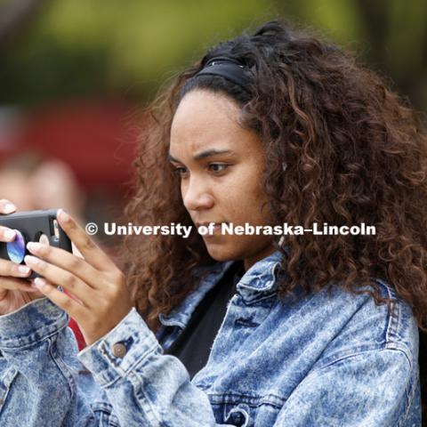 Jamaica Brielle takes a photo of the Grit and Glory words in front of the fountain. In Our Grit, Our Glory brand reveal party on city campus at the Nebraska Union. August 30, 2018. Photo by Craig Chandler / University Communication.