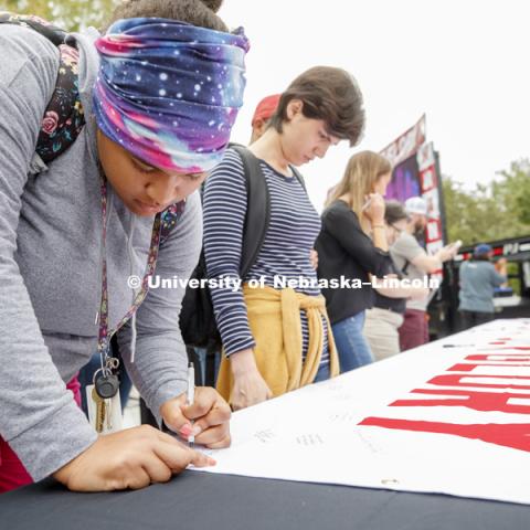 Everyone was asked to sign on a banner what girt and glory meant for them. In Our Grit, Our Glory brand reveal party on city campus at the Nebraska Union. August 30, 2018. Photo by Craig Chandler / University Communication.