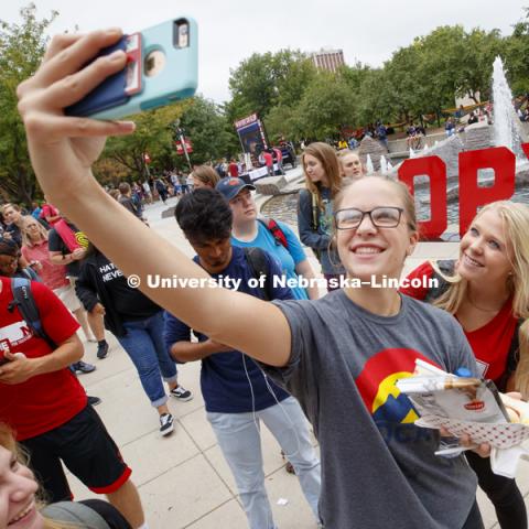 Taylor Eickhoff, senior from Lincoln, and Ali Bartels, freshman from Gothenburg, take the photo to post on social media. In Our Grit, Our Glory brand reveal party on city campus at the Nebraska Union. August 30, 2018. Photo by Craig Chandler / University Communication.