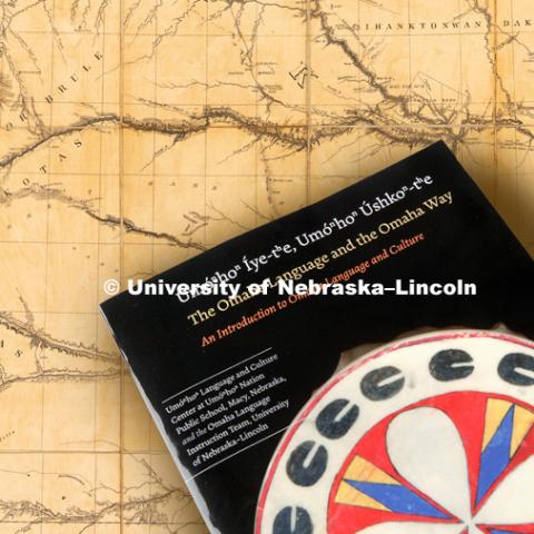 A group of university students and staff worked with members of Omaha Nation to produce a textbook of the Omaha language. Omaha Tribal Language book. Composited with a Library of Congress 1850s map of the northern Great Plains including Nebraska, Kansas and the Dakotas. September 10, 2018. Photo by Craig Chandler / University Communication.