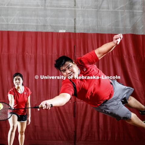 Frederick Chua is a junior business management student at the College of Business, and president of the badminton club, dives as Poh Ling Lim backs up his dive. October 24, 2018. Photo by Craig Chandler / University Communication.