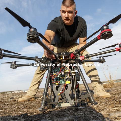 Nebraska's Adam Plowcha, graduate student in computer science and Navy veteran, pilots a large UACV drone that is being developed to drill holes and place sensors in soil. The vehicle has multiple applications, from agriculture to national defense. October 26, 2018. Photo by Craig Chandler / University Communication.