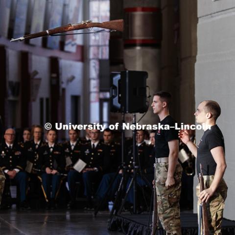 Army Cadet Tyler Mona throws his rifle to Army Cadet Jared Polack during a display by the Pershing Rifles to start the ceremony. A new display commemorating the World War I service of Nebraskans and University of Nebraska students was dedicated during a November 11 ceremony at Memorial Stadium. November 11, 2018. Photo by Craig Chandler / University Communication.