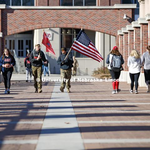 Army veteran Jared Collins, undergraduate Natalie Kraft, a Navy veteran, undergraduate and Marine veteran Jake Post and Jerod Post, '13 and a Marine veteran, begin their march to Iowa City. Beginning of veterans Ruck March, which uses Nebraska and Iowa veterans to carry the game ball from Lincoln to Iowa City. November 14, 2018. Photo by Craig Chandler / University Communication.