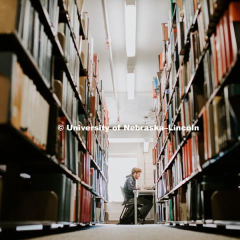 Student Studying in the stacks at Love Library. December 9, 2018. Photo by Justin Mohling, University Communication.