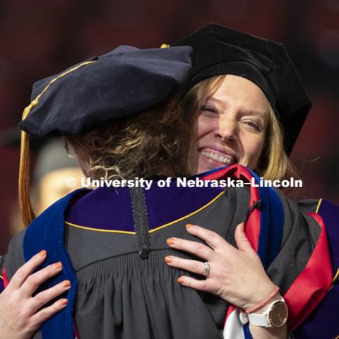 Lori Hoetger, PhD in Psychology, hugs Professor Eve Brank after Hoetger was hooded Friday at the Graduate Commencement and Hooding in Pinnacle Bank Arena. December 14, 2018. Photo by Craig Chandler / University Communication.