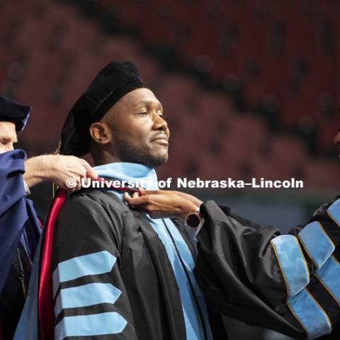Ivey Brown, Doctor of Education, has his hood placed on his shoulders at the Graduate Commencement and Hooding in Pinnacle Bank Arena. December 14, 2018. Photo by Craig Chandler / University Communication.