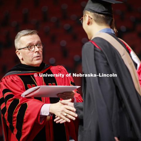 Chancellor Ronnie Green congratulated each graduate at Graduate Commencement and Hooding in Pinnacle Bank Arena. December 14, 2018. Photo by Craig Chandler / University Communication.
