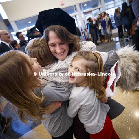 Janel Simons hugs her son, Henri, and nieces Lily and Juliana Petersen after she received her doctoral in English degree during the Graduate Commencement and Hooding ceremony in Pinnacle Bank Arena. December 14, 2018. Photo by Craig Chandler / University Communication.