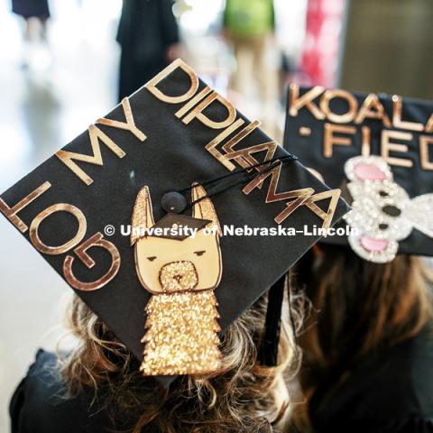 Julia Zoryana and Anastasia Stepanyuk had pun with their mortarboards Saturday. Undergraduate Commencement in Pinnacle Bank Arena. December 15, 2018. Photo by Craig Chandler / University Communication.