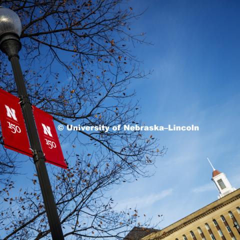 New banners to celebrate the university's 150th anniversary are being hung on campus. December 18, 2018. Photo by Craig Chandler / University Communication.