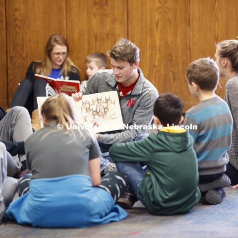 Jacob Polk, freshman in Economics, from Hooper, NE, reads to children at the YMCA of Lincoln-Northeast as part of the Husker Reading Challenge. The UNL students reading at the Y are part of the Chancellor's Leadership Class. Students, faculty and staff are invited to honor King’s legacy through a day of service. In collaboration with Prosper Lincoln and Read Aloud Lincoln, the Center for Civic Engagement at Nebraska will host the reading challenge. January 21, 2019. Photo by Craig Chandler / University Communication.