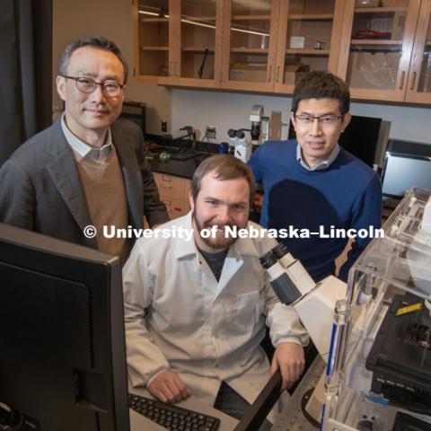 Research done by Ruiguo Yang (back right), Jung Yul Lim (back left), and a team of students, including Jordan Rosenbohm, seeks to understand how individual cells communicate with each other as they respond to environmental changes. January 24, 2019. Photo by Greg Nathan / University Communication.