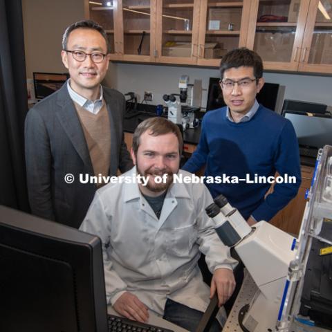Research done by Ruiguo Yang (back right), Jung Yul Lim (back left), and a team of students, including Jordan Rosenbohm, seeks to understand how individual cells communicate with each other as they respond to environmental changes. January 24, 2019. Photo by Greg Nathan / University Communication.