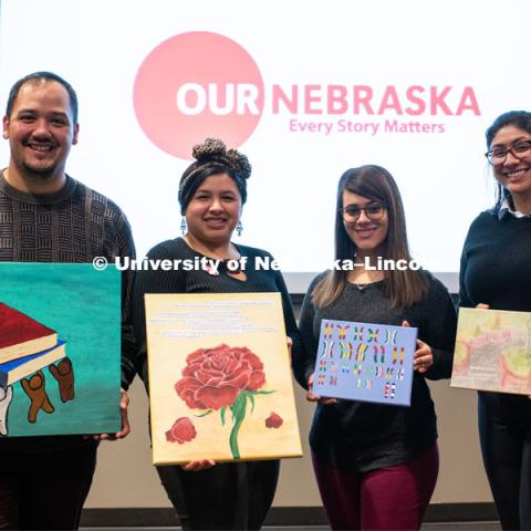 Our Nebraska: Express Yourself Expo in the Oasis Center. Students holding their artwork in front of the event logo. January 31, 2019. Photo by Justin Mohling / University Communication.