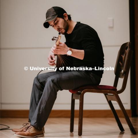 Our Nebraska: Express Yourself Expo in the Oasis Center. A Turkish student plays a sting instrument for the Expo. January 31, 2019. Photo by Justin Mohling / University Communication.