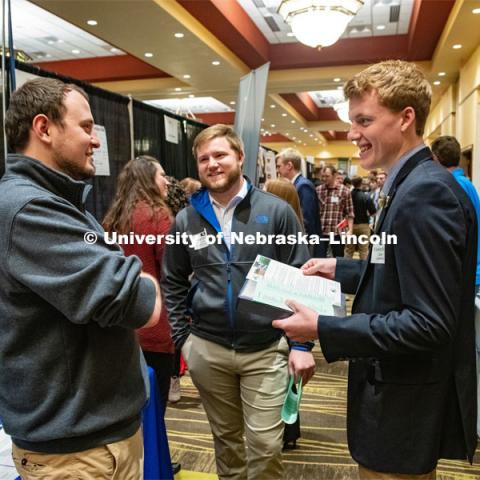 Jared Muhlbach and Carson Hicks talk with a recruiter from Farmers Cooperative at the STEM Career Fair (Science, Technology, Engineering, and Math) in Embassy Suites. Sponsored by Career Services. February 12, 2019. Photo by Gregory Nathan / University Communication.