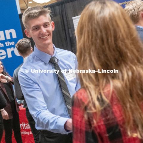Ryan Soderquist speaks with a recruit at the STEM Career Fair (Science, Technology, Engineering, and Math) at Embassy Suites. Sponsored by Career Services. February 12, 2019. Photo by Gregory Nathan / University Communication.