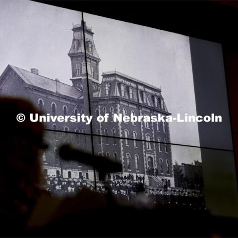 Kay Logan Peters is silhouetted by a photo of University Hall as she gives a special Nebraska Lecture as part of Charter Week on the University's early architectural history before a crowd of more than 300 people. February 12, 2019. Photo by Craig Chandler/University Communication.