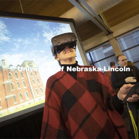 Jane Green tries out a virtual reality reconstruction of Nebraska Hall under the watchful guidance of NET's Mike Fields. Kay Logan Peters gives a special Nebraska Lecture as part of Charter Week on the University's early architectural history before a crowd of more than 300 people. February 12, 2019. Photo by Craig Chandler/University Communication.