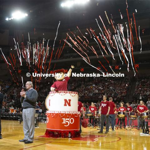 Herbie Husker pops out of a birthday cake as he and head football coach Scott Frost, Chancellor Ronnie Green and Athletic Director Bill Moos help celebrate the university's 150th birthday at the halftime show during the Huskers men’s basketball game. The Huskers played against Minnesota. February 13, 2019. Photo by Isabel Thalken / Husker Athletics.