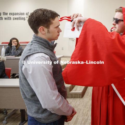 The Innocents Society taps Spencer Nussrallah, junior in finance, into the society Monday morning during a business class. February 25, 2019. Photo by Craig Chandler / University Communication.