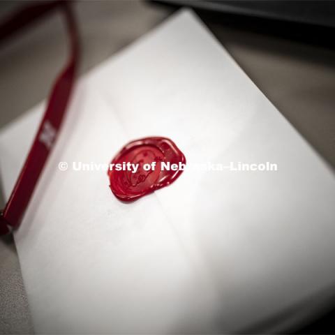 The invitation for the society is sealed in wax. Innocents Society taps Spencer Nussrallah, junior in finance, into the society Monday morning. February 25, 2019. Photo by Craig Chandler / University Communication