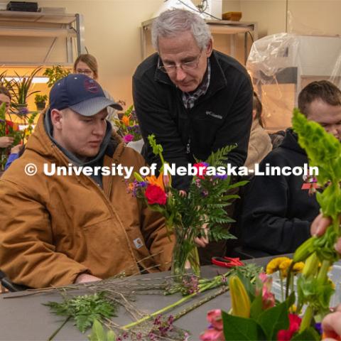 Stacy Adams (center), associate professor of practice in agronomy and horticulture, helps two students create their arrangements in Floral Design class Hort 261- Floral Design 1, in Plant Sciences Hall. Students create floral arrangements. February 26, 2019. Photo by Gregory Nathan / University Communication.