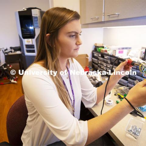 Alex Hruby, Senior in Biological Systems Engineering, works on her research project in the Institute for Rehabilitation Science and Engineering at Madonna Rehabilitation Hospital's Lincoln campus. The device will help low mobility patients communicate with the nursing staff while in the hospital. March 12, 2019. Photo by Craig Chandler / University Communication.