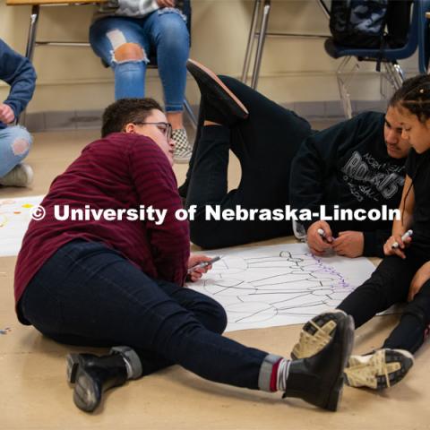 Grace Stallworth (right), project coordinator for Worlds of Connections, plays a network science game with a middle-school student. A new research and outreach program is engaging middle-school youth with science in novel ways, with the aim of increasing curiosity and interest in health careers. Worlds of Connections. April 3, 2019. Photo by Greg Nathan / University Communication