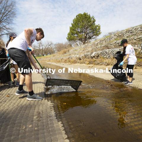 Alec Skinner pulls debris from Deadman's Run as teams worked to clean up trash in the run east of East Campus. More than 2,500 University of Nebraska–Lincoln students, faculty and staff volunteered for the Big Event on April 6, completing service projects across the community. Now in its 13th year at Nebraska, the Big Event has grown to be the university's single largest student-run community service project. April 6, 2019. Photo by Craig Chandler / University Communication.