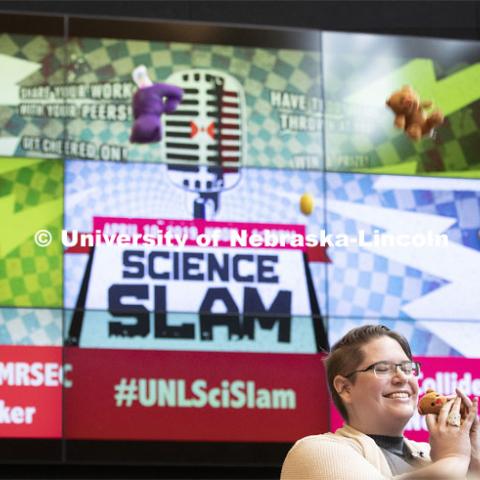 Recent graduate Nicole Benker holds a teddy bear thrown onto the stage in appreciation of her performance. Nebraska’s fourth annual Science Slam held at Wick Alumni Center. April 9 2019. Photo by Craig Chandler / University Communication.