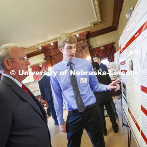 Chad Lammers of Hartington, NE, discusses his research "Elucidating the Effects of Domestication and Modern Breeding on Root Plasticity for Drought Adaptation in Wheat" with Sen. Tim Gragert of District 40. State Senators Research Fair at the Ferguson House. April 16, 2019. Photo by Craig Chandler / University Communication.