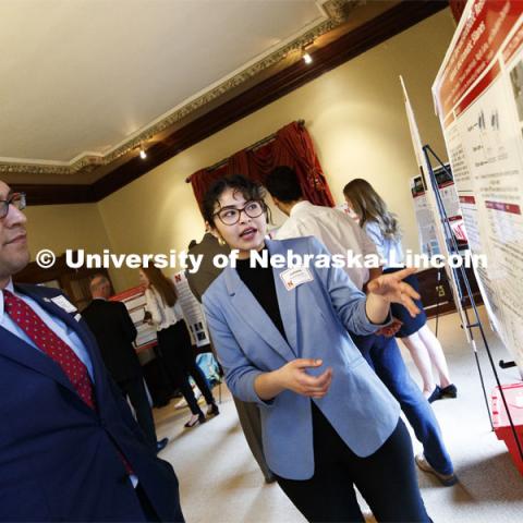 Juliana Rodriguez of Omaha explains her research "Surface Interaction of Antibiotic Resistant Bacteria: An Effective Step towards Robust Biosensor Development" to Sen. Tony Vargas of District 7. State Senators Research Fair at the Ferguson House. April 16, 2019. Photo by Craig Chandler / University Communication.