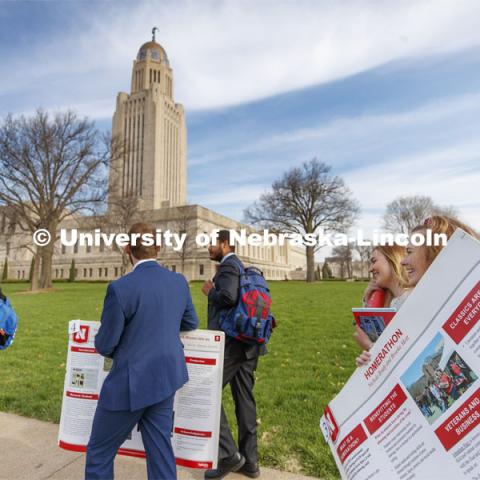 Nichole Brady and Brooke Mott talks as they carry their Homerathon poster from the Ferguson House to the Capitol Tuesday morning. Students presented their posters to multiple senators and then displayed the posters in the capitol. State Senators Research Fair at the Ferguson House. April 16, 2019. Photo by Craig Chandler / University Communication.