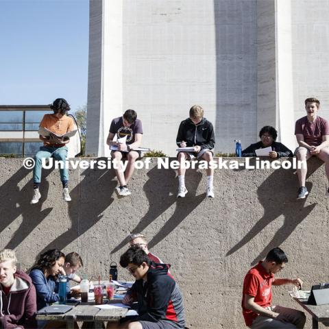 Sitting in the Sheldon sculpture garden, students in Music Theory 166 enjoy the weather during the last class period of the semester that, for some, probably seems as long as the shadows on the wall. City Campus.  April 26, 2019. Photo by Craig Chandler / University Communication.